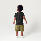 Child wearing a black 2lowsierra 2ls t-shirt and green shorts on a white background