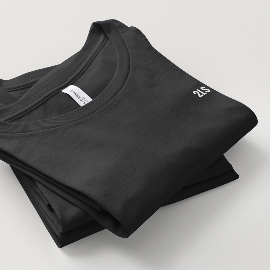 Folded black t-shirt with a brand label on a light gray background 2lowisierra 2LS tshirt