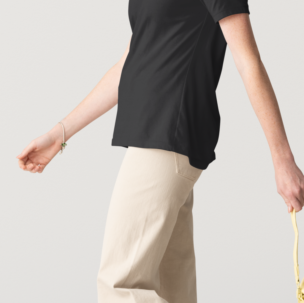 Person wearing a black top and beige pants, holding a yellow handbag on a light gray background 2lowsierra 2LS cadillac escalade gmc sierra