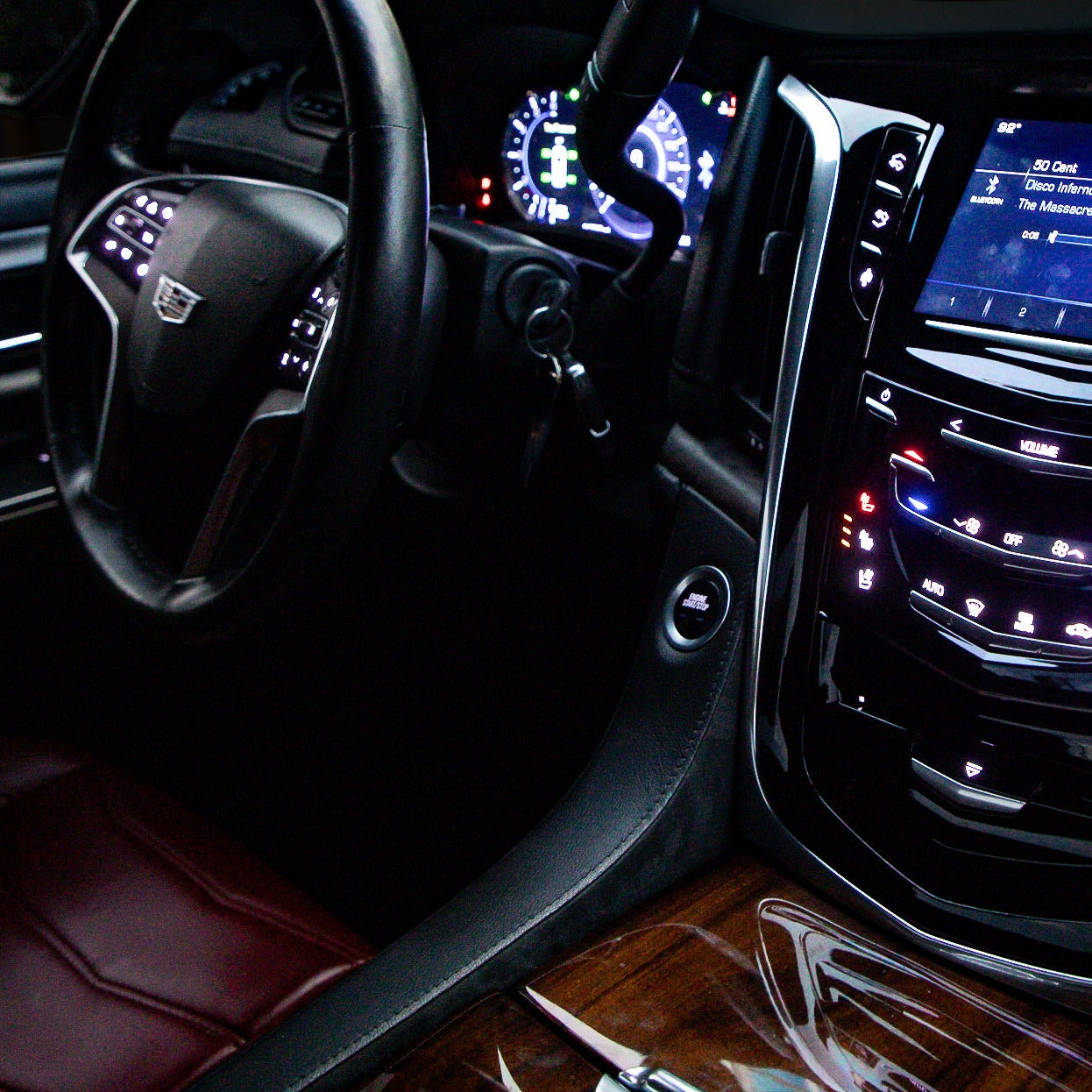 GMC Sierra Denali Cadillac Escalade 2lowsierra lowrider truck show truck luxury truck houston tow install parts swap Car interior with dashboard and steering wheel in a dark setting