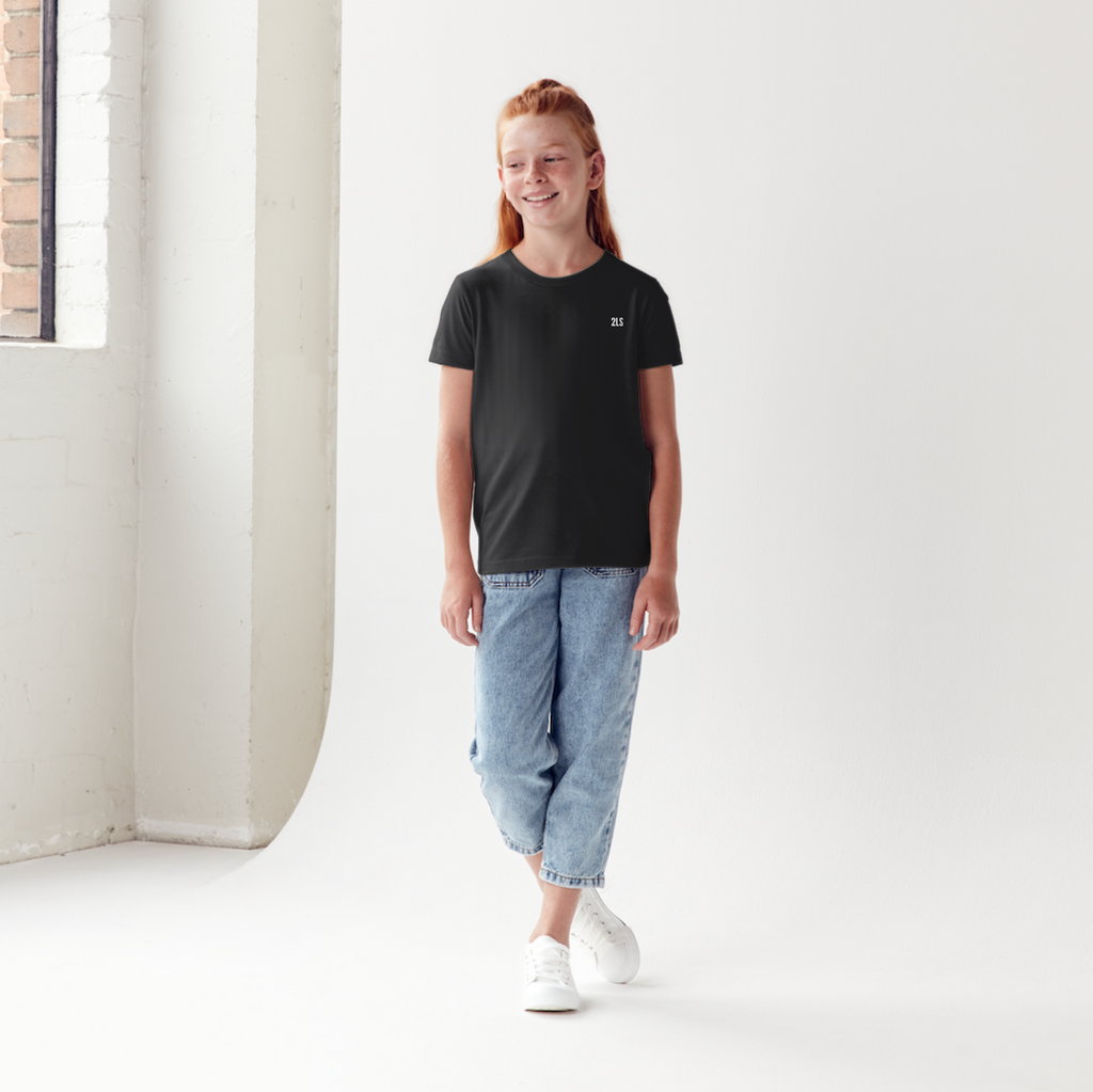 Person wearing a black t-shirt and light blue jeans standing in a minimalistic  2lowsierra 2ls room.