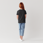 Person wearing a black t-shirt and light blue jeans on a plain background 2ls 2lowsierra