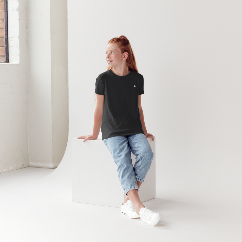 Woman sitting on a white block in a minimalistic room