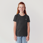 Young girl wearing a black t-shirt with a small logo on a light gray background youth 2LS tshirt 2lowsierra